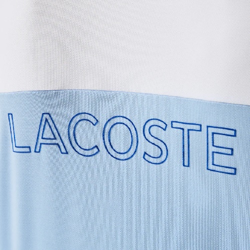 polo Lacoste sport color-block bleu ciel blanc polyester respirant ultra dry marquage lacoste dos boutique sport aventure à Orange sport et mode
